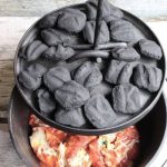 charcoal briquettes on dutch oven cover